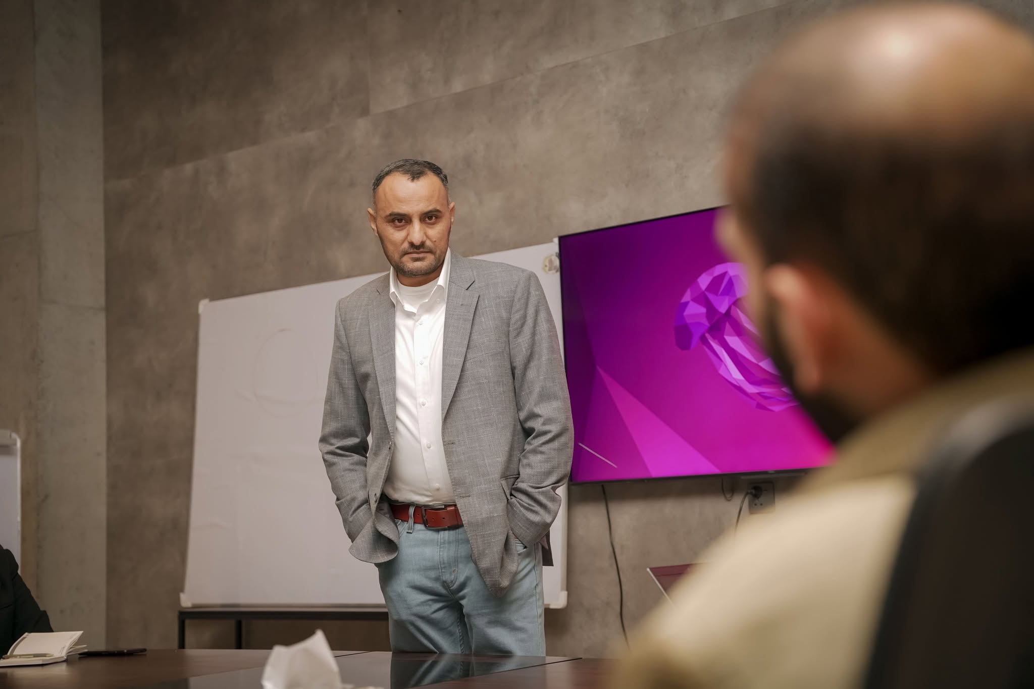 Portrait of Khawar Zaman in a boardroom